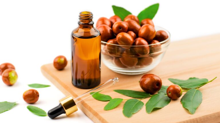 jojoba-oil-in-a-bottle-with-a-dropper-on-a-wooden-table-with-ripe-jojoba-fruits--chinese-date-oil-and-fruit-1351668799-650e9f2b007d4df1a6a4a3f1425ea075